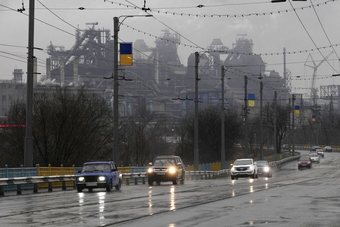 Cars drive past the Mariupol Metallurgical Plant in Mariupol, Ukraine, Thursday, Feb. 24, 2022. Ukraine's border guard agency says that the Russian military has attacked the country from neighboring Belarus. The agency said that the Russian troops unleashed artillery barrage as part of an attack backed by Belarus. (AP Photo/Sergei Grits) Cars drive past the Mariupol Metallurgical Plant in Mariupol, Ukraine, Thursday, Feb. 24, 2022. Ukraine's border guard agency says that the Russian military has attacked the country from neighboring Belarus. The agency said that the Russian troops unleashed artillery barrage as part of an attack backed by Belarus. (AP Photo/Sergei Grits)