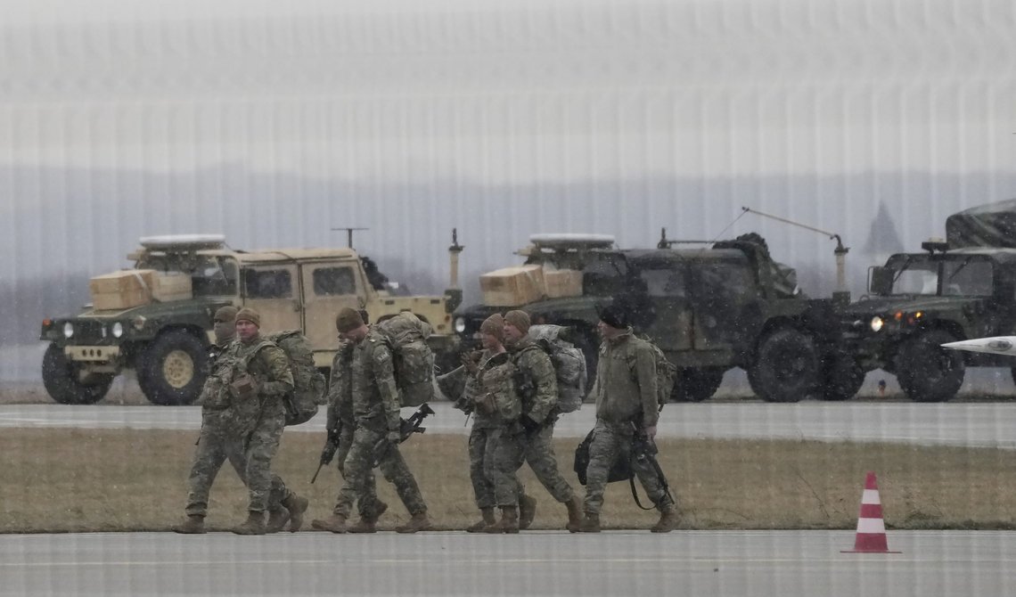 U.S. Army troops of the 82nd Airborne Division unloading vehicles from a transport plane after arriving from Fort Bragg at the Rzeszow-Jasionka airport in southeastern Poland, on Sunday, Feb. 6, 2022. Additional U.S. troops are arriving in Poland after President Joe Biden ordered the deployment of 1,700 soldiers here amid fears of a Russian invasion of Ukraine. Some 4,000 U.S. troops have been stationed in Poland since 2017. (AP Photo/Czarek Sokolowski) U.S. Army troops of the 82nd Airborne Division unloading vehicles from a transport plane after arriving from Fort Bragg at the Rzeszow-Jasionka airport in southeastern Poland, on Sunday, Feb. 6, 2022. Additional U.S. troops are arriving in Poland after President Joe Biden ordered the deployment of 1,700 soldiers here amid fears of a Russian invasion of Ukraine. Some 4,000 U.S. troops have been stationed in Poland since 2017. (AP Photo/Czarek Sokolowski)