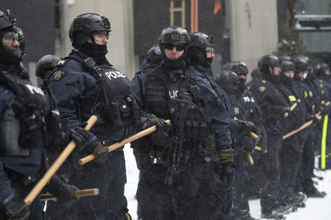 Police block Sparks Street as they take action to put an end to a protest, which started in opposition to mandatory COVID-19 vaccine mandates and grew into a broader anti-government demonstration and occupation, in Ottawa, Ontario, Saturday, Feb. 19, 2022. (Justin Tang/The Canadian Press via AP) Police block Sparks Street as they take action to put an end to a protest, which started in opposition to mandatory COVID-19 vaccine mandates and grew into a broader anti-government demonstration and occupation, in Ottawa, Ontario, Saturday, Feb. 19, 2022. (Justin Tang/The Canadian Press via AP)