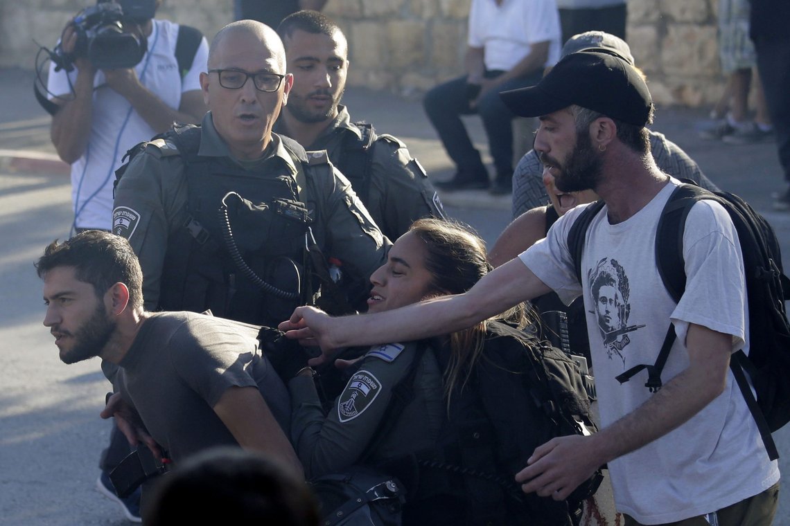 Israeli border police scuffle with protesters in the Sheikh Jarrah neighborhood of east Jerusalem, where several Palestinian families are under imminent threat of forcible eviction from their homes, Friday, May 14, 2021. (AP Photo/ Mahmoud Illean) Israeli border police scuffle with protesters in the Sheikh Jarrah neighborhood of east Jerusalem, where several Palestinian families are under imminent threat of forcible eviction from their homes, Friday, May 14, 2021. (AP Photo/ Mahmoud Illean)