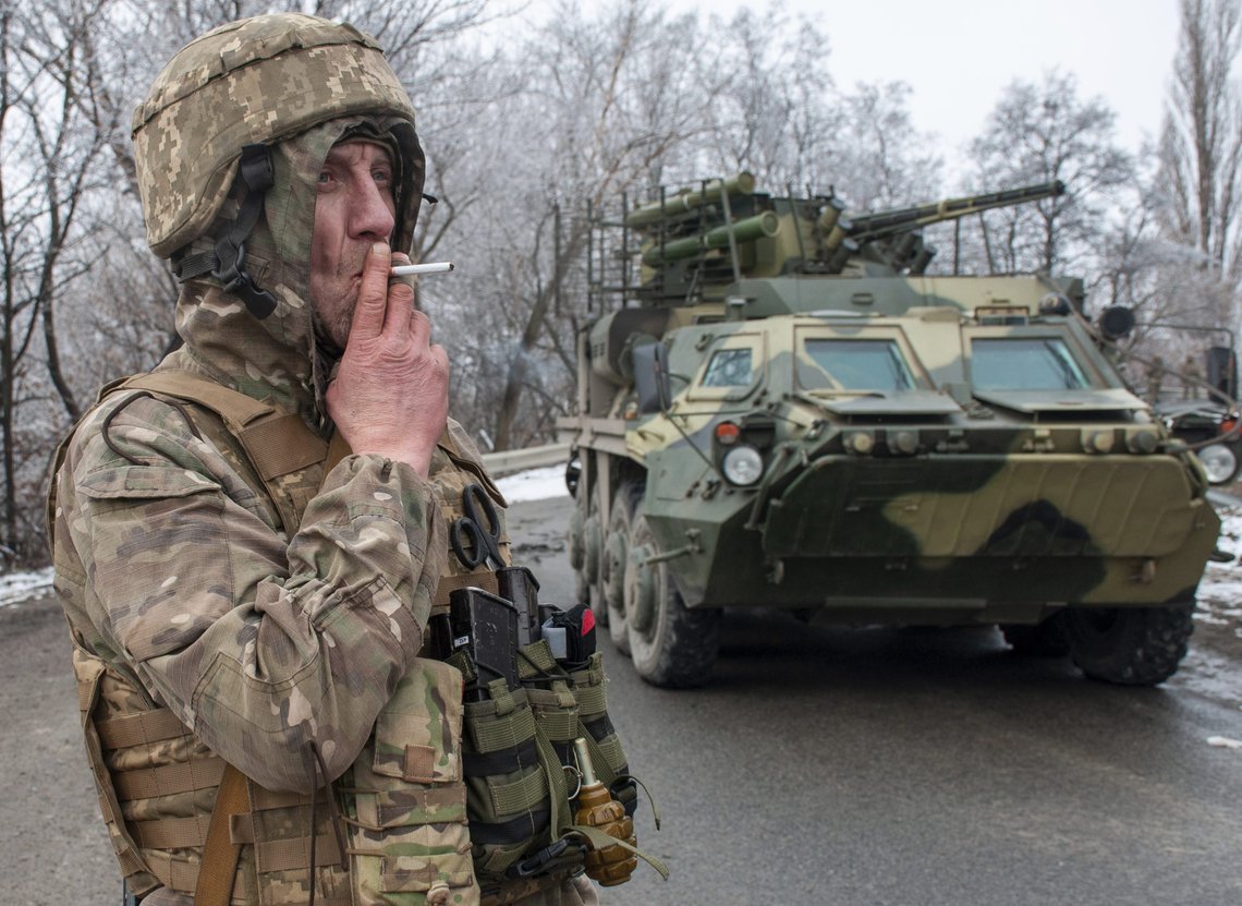 A Ukrainian soldier smokes a cigarette on his position at an armored vehicle outside Kharkiv, Ukraine, Saturday, Feb. 26, 2022. President Volodymyr Zelenskyy claimed Saturday that Ukraine's forces had repulsed the assault and vowed to keep fighting. "We will win," Zelenskyy said. (AP Photo/Andrew Marienko ) A Ukrainian soldier smokes a cigarette on his position at an armored vehicle outside Kharkiv, Ukraine, Saturday, Feb. 26, 2022. President Volodymyr Zelenskyy claimed Saturday that Ukraine's forces had repulsed the assault and vowed to keep fighting. "We will win," Zelenskyy said. (AP Photo/Andrew Marienko )