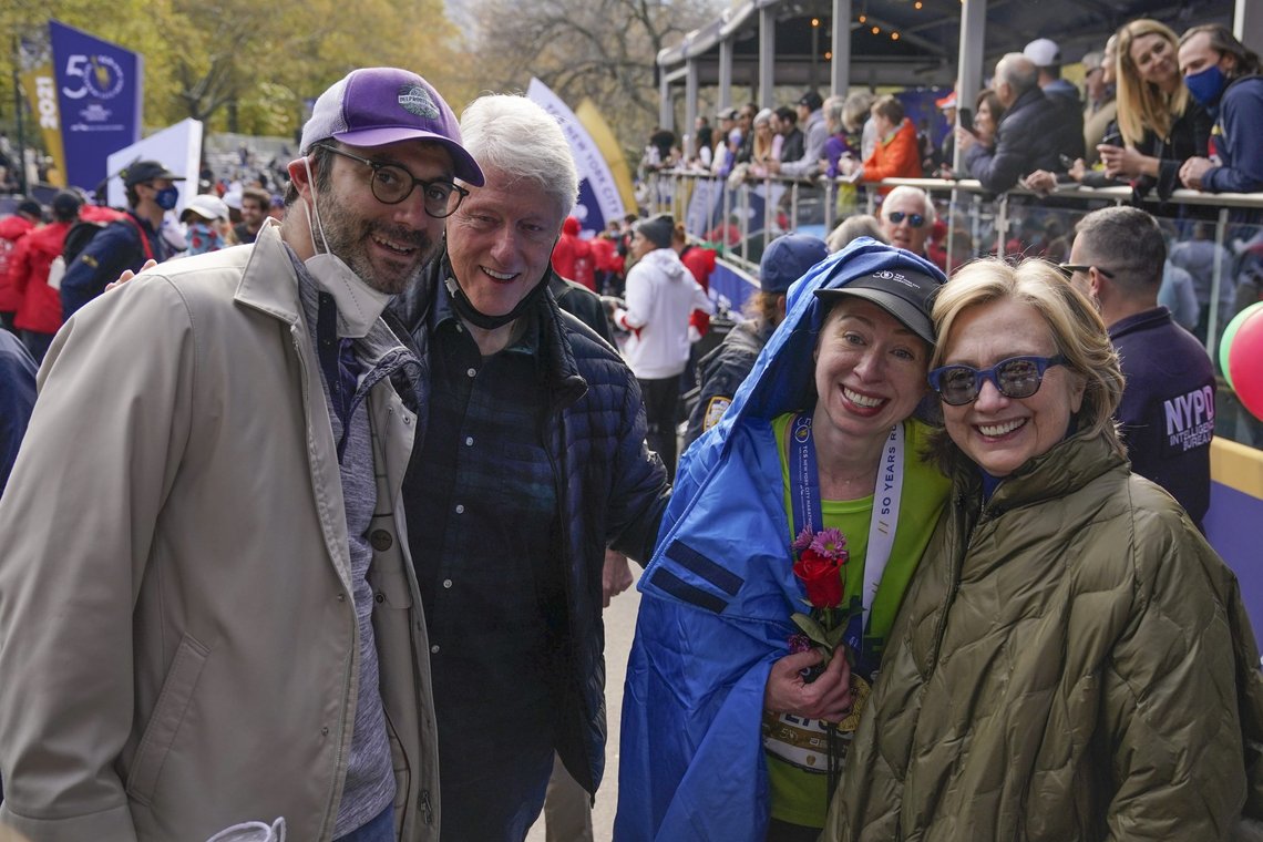 After completing the New York City marathon, Chelsea Clinton, second from right, poses for for a picture with her parents Hillary Clinton, right, Bill Clinton, second from left, and her husband, Marc Mezvinsky, at the finish line in New York, Sunday, Nov. 7, 2021. (AP Photo/Seth Wenig) After completing the New York City marathon, Chelsea Clinton, second from right, poses for for a picture with her parents Hillary Clinton, right, Bill Clinton, second from left, and her husband, Marc Mezvinsky, at the finish line in New York, Sunday, Nov. 7, 2021. (AP Photo/Seth Wenig)