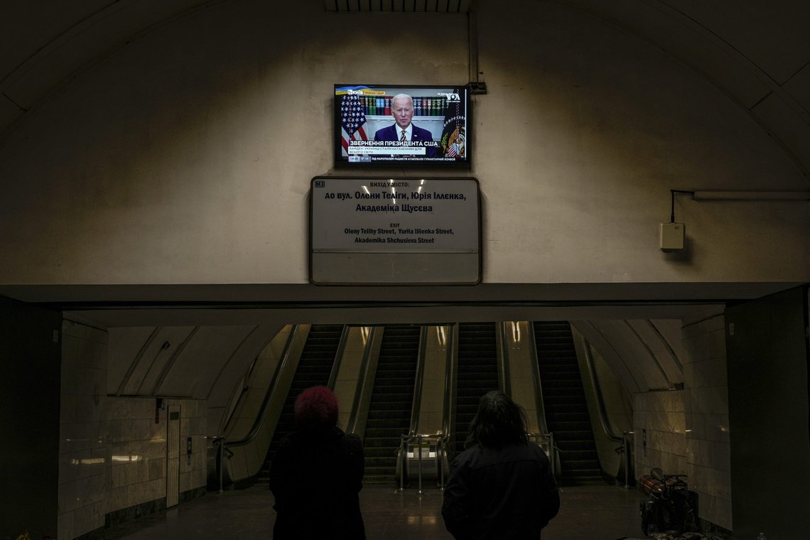Two women watch U.S. President Joe Biden making statements on a news channel in a subway station turned into a shelter in Kyiv, Ukraine, Tuesday, March 8, 2022. Demands for ways to safety evacuate civilians have surged along with intensifying shelling by Russian forces, who have made significant advances in southern Ukraine but stalled in some other regions. Efforts to put in place cease-fires along humanitarian corridors have repeatedly failed amid Russian shelling. (AP Photo/Vadim Ghirda) Two women watch U.S. President Joe Biden making statements on a news channel in a subway station turned into a shelter in Kyiv, Ukraine, Tuesday, March 8, 2022. Demands for ways to safety evacuate civilians have surged along with intensifying shelling by Russian forces, who have made significant advances in southern Ukraine but stalled in some other regions. Efforts to put in place cease-fires along humanitarian corridors have repeatedly failed amid Russian shelling. (AP Photo/Vadim Ghirda)