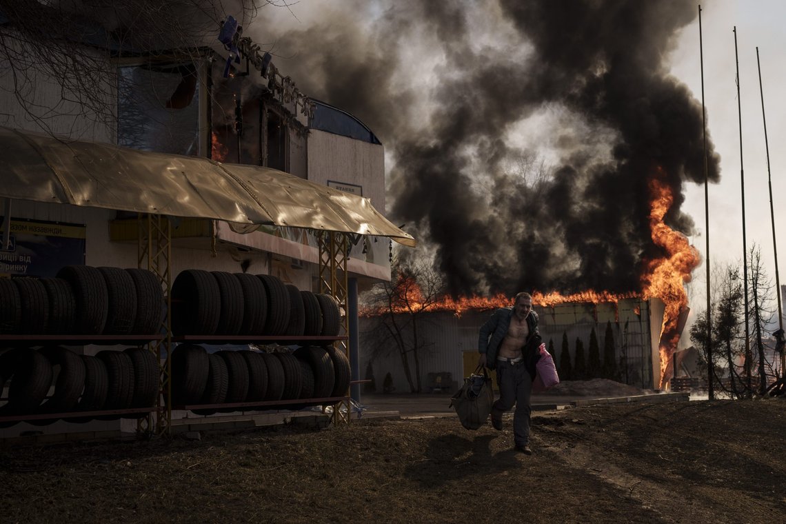 A man recovers items from a burning shop following a Russian attack in Kharkiv, Ukraine, Friday, March 25, 2022. (AP Photo/Felipe Dana) A man recovers items from a burning shop following a Russian attack in Kharkiv, Ukraine, Friday, March 25, 2022. (AP Photo/Felipe Dana)