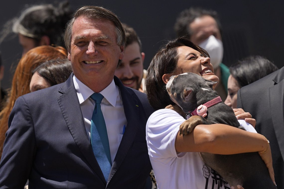 Accompanied by her husband, Brazil’s President Jair Bolsonaro, first lady Michelle Bolsonaro holds a dog that traveled with Brazilians stranded in Ukraine, at the air force base in Brasilia, Thursday, March 10, 2022. Dozens of Brazilians, along with about 20 Ukrainian citizens and a handful of other Latin Americans arrived from Poland on a Brazilian Air Force plane Thursday morning. Brazil has pledged to repatriate its citizens and has offered Ukrainian refugees asylum. (AP Photo/Eraldo Peres) Accompanied by her husband, Brazil’s President Jair Bolsonaro, first lady Michelle Bolsonaro holds a dog that traveled with Brazilians stranded in Ukraine, at the air force base in Brasilia, Thursday, March 10, 2022. Dozens of Brazilians, along with about 20 Ukrainian citizens and a handful of other Latin Americans arrived from Poland on a Brazilian Air Force plane Thursday morning. Brazil has pledged to repatriate its citizens and has offered Ukrainian refugees asylum. (AP Photo/Eraldo Peres)