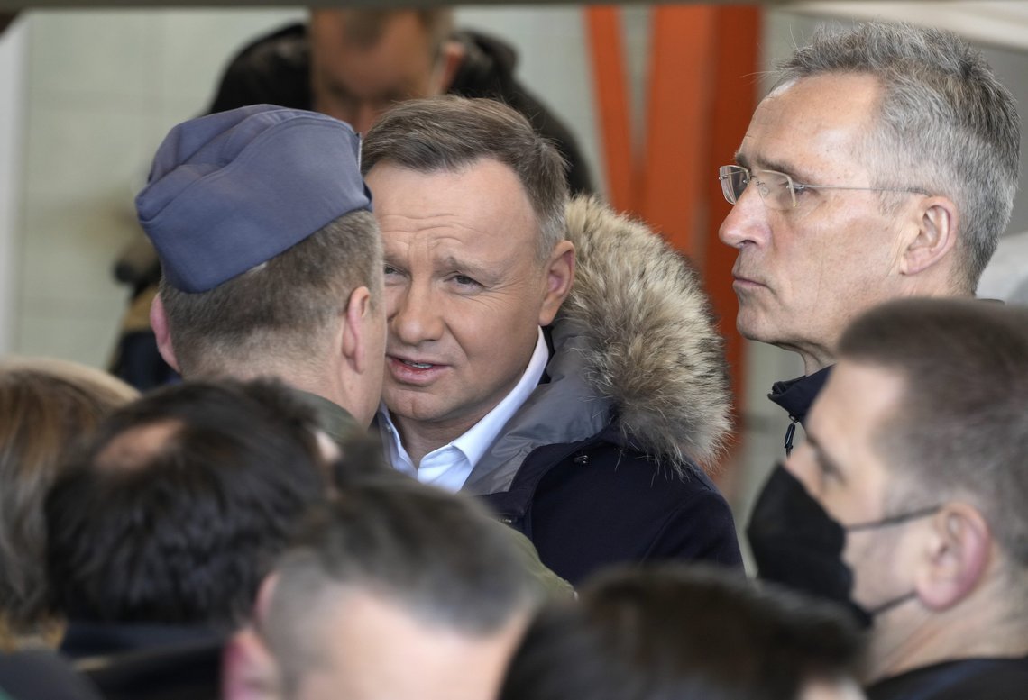 NATO Secretary General Jens Stoltenberg, right, and Polish President Andrzej Duda greet the media and members of the military at Lask air base in Poland, Tuesday, March 1, 2022. Their meeting took place as Russian shelling pounded civilian targets in Ukraine's second-largest city again Tuesday and a 40-mile convoy of tanks and other vehicles threatened the capital Kyiv. (AP Photo/Czarek Sokolowski) NATO Secretary General Jens Stoltenberg, right, and Polish President Andrzej Duda greet the media and members of the military at Lask air base in Poland, Tuesday, March 1, 2022. Their meeting took place as Russian shelling pounded civilian targets in Ukraine's second-largest city again Tuesday and a 40-mile convoy of tanks and other vehicles threatened the capital Kyiv. (AP Photo/Czarek Sokolowski)