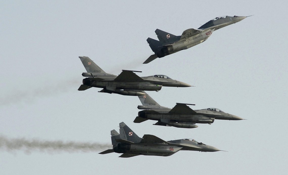 FILE - Two Polish Air Force Russian made Mig 29's fly above and below two Polish Air Force U.S. made F-16's fighter jets during the Air Show in Radom, Poland, on Aug. 27, 2011. In a private video call with American lawmakers over the weekend, Ukrainian President Volodymyr Zelenskyy made a “desperate” plea to the United States to help Kyiv get more warplanes to fight Russia's invasion and retain control of its airspace. (AP Photo/Alik Keplicz, File) FILE - Two Polish Air Force Russian made Mig 29's fly above and below two Polish Air Force U.S. made F-16's fighter jets during the Air Show in Radom, Poland, on Aug. 27, 2011. In a private video call with American lawmakers over the weekend, Ukrainian President Volodymyr Zelenskyy made a “desperate” plea to the United States to help Kyiv get more warplanes to fight Russia's invasion and retain control of its airspace. (AP Photo/Alik Keplicz, File)