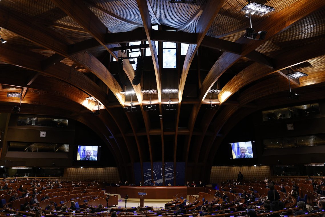 Members of the Parliamentary Assembly of the Council of Europe (PACE) listen to a live video speech by Ukraine's Prime Minister Denys Shmyhal, Monday, March 14, 2022 in Strasbourg, eastern France. The Parliamentary Assembly of the Council of Europe debates the consequences of the Russian invasion of Ukraine at a two-day extraordinary session. (AP Photo/Jean-Francois Badias) Members of the Parliamentary Assembly of the Council of Europe (PACE) listen to a live video speech by Ukraine's Prime Minister Denys Shmyhal, Monday, March 14, 2022 in Strasbourg, eastern France. The Parliamentary Assembly of the Council of Europe debates the consequences of the Russian invasion of Ukraine at a two-day extraordinary session. (AP Photo/Jean-Francois Badias)