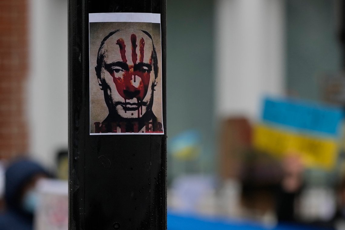 An anti Russian President Putin poster placed on a traffic light column as Pro-Ukraine demonstrators protest against the Russian invasion of Ukraine in front of the Russian Embassy in London, Tuesday, March 1, 2022. Russian shelling pounded civilian targets in Ukraine's second-largest city Tuesday and a 40-mile convoy of tanks and other vehicles threatened the capital — tactics Ukraine's embattled president said were designed to force him into concessions in Europe's largest ground war in generations. (AP Photo/Alastair Grant) An anti Russian President Putin poster placed on a traffic light column as Pro-Ukraine demonstrators protest against the Russian invasion of Ukraine in front of the Russian Embassy in London, Tuesday, March 1, 2022. Russian shelling pounded civilian targets in Ukraine's second-largest city Tuesday and a 40-mile convoy of tanks and other vehicles threatened the capital — tactics Ukraine's embattled president said were designed to force him into concessions in Europe's largest ground war in generations. (AP Photo/Alastair Grant)