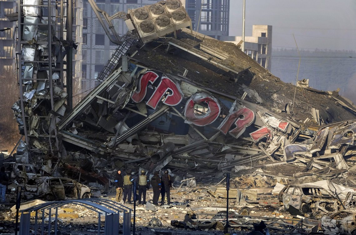 People examine the damage after shelling of a shopping center, in Kyiv, Ukraine, Monday, March 21, 2022. (AP Photo/ (AP Photo/Efrem Lukatsky) People examine the damage after shelling of a shopping center, in Kyiv, Ukraine, Monday, March 21, 2022. (AP Photo/ (AP Photo/Efrem Lukatsky)