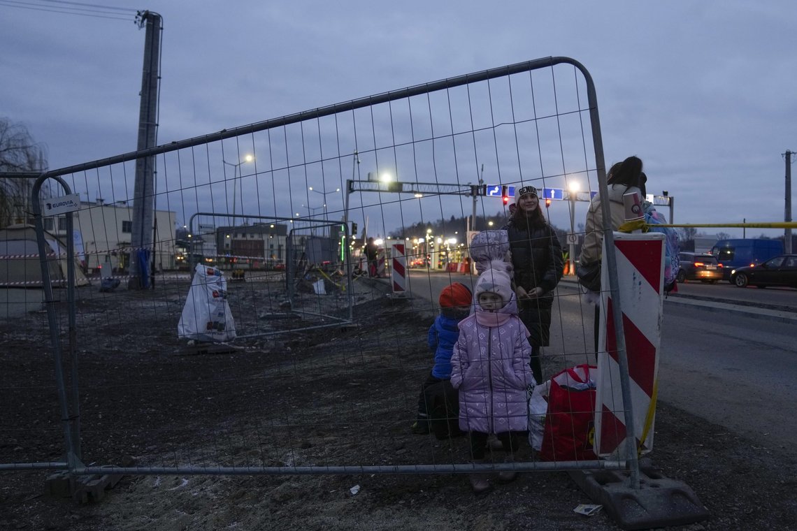 Women and children stand along the road after fleeing from the Ukraine and arriving at the border crossing in Medyka, Poland, Saturday, March 5, 2022. (AP Photo/Markus Schreiber) Women and children stand along the road after fleeing from the Ukraine and arriving at the border crossing in Medyka, Poland, Saturday, March 5, 2022. (AP Photo/Markus Schreiber)