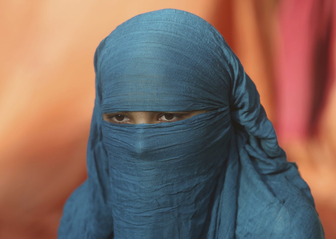 Fourteen-year-old Neha sits during an interview Wednesday Nov. 11, 2020, in Karachi, Pakistan. Neha's family forced her to marry a 45-year-old Muslim man, who first made her convert from Christianity to Islam. She's among hundreds of Christian and Hindu girls from poor families who are forced to convert each year, usually ahead of being married off to older Muslim men. Activists say the practice has accelerated during lockdowns against the coronavirus, when girls are out of school and more visible, bride traffickers are more active on the Internet and families are more in debt. (AP Photo/Fareed Khan) Fourteen-year-old Neha sits during an interview Wednesday Nov. 11, 2020, in Karachi, Pakistan. Neha's family forced her to marry a 45-year-old Muslim man, who first made her convert from Christianity to Islam. She's among hundreds of Christian and Hindu girls from poor families who are forced to convert each year, usually ahead of being married off to older Muslim men. Activists say the practice has accelerated during lockdowns against the coronavirus, when girls are out of school and more visible, bride traffickers are more active on the Internet and families are more in debt. (AP Photo/Fareed Khan)