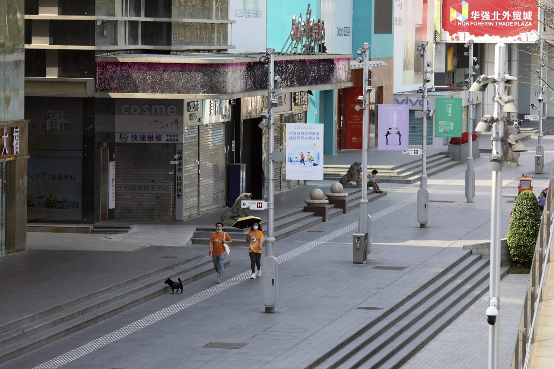 Residents walk their dog past shuttered shops in the Huaqiangbei area, the world's biggest electronics market, in Shenzhen, southern China's Guangdong province Monday, March 14, 2022. Officials on Sunday locked down Shenzhen due to rising coronavirus infections, which has 17.5 million people and is a major tech and finance hub that borders Hong Kong. (Chinatopix Via AP) Residents walk their dog past shuttered shops in the Huaqiangbei area, the world's biggest electronics market, in Shenzhen, southern China's Guangdong province Monday, March 14, 2022. Officials on Sunday locked down Shenzhen due to rising coronavirus infections, which has 17.5 million people and is a major tech and finance hub that borders Hong Kong. (Chinatopix Via AP)