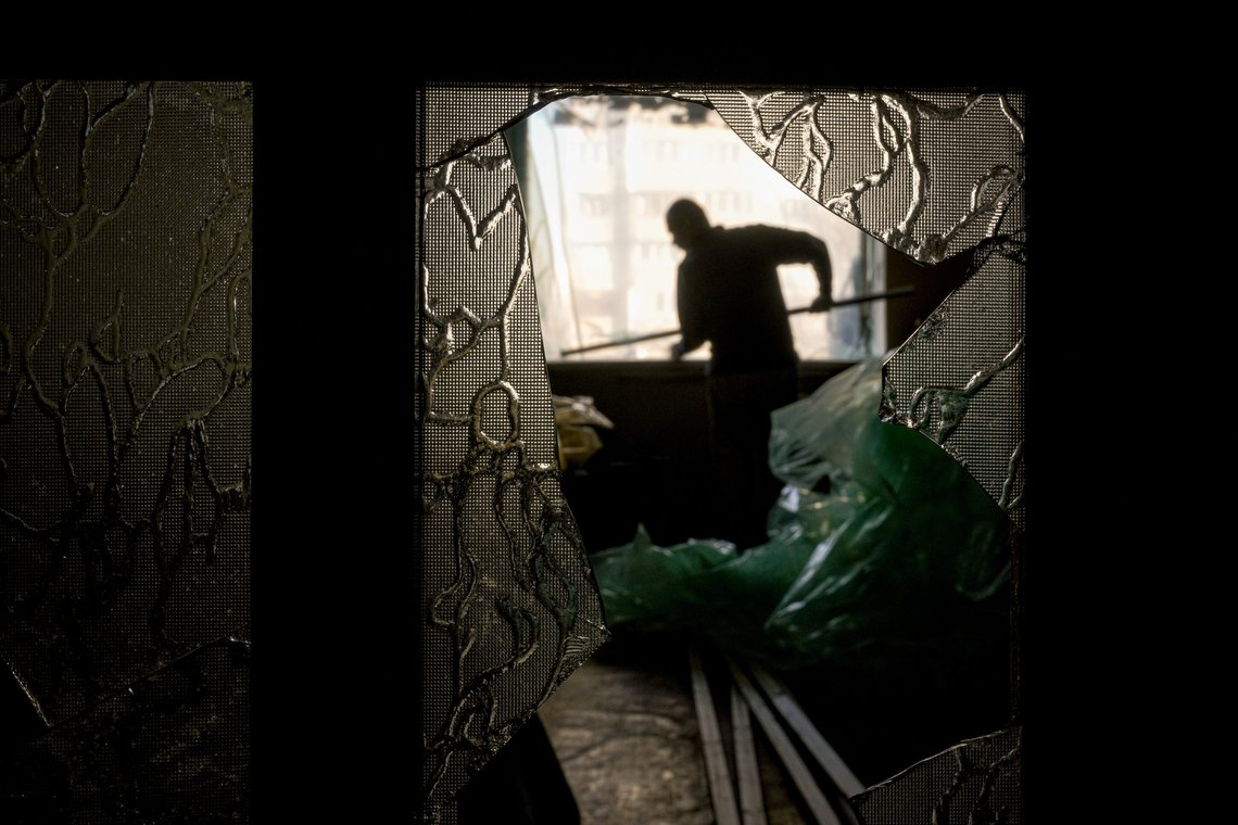Slava Chikov covers the shattered window of his living room with a plastic sheet in a building damaged by a bombing the previous day in Kyiv, Ukraine, Monday, March 21, 2022. As Russia intensified its effort to pound Mariupol into submission, its ground offensive in other parts of Ukraine has become bogged down. Western officials and analysts say the conflict is turning into a grinding war of attrition, with Russia bombarding cities.(AP Photo/Vadim Ghirda) Slava Chikov covers the shattered window of his living room with a plastic sheet in a building damaged by a bombing the previous day in Kyiv, Ukraine, Monday, March 21, 2022. As Russia intensified its effort to pound Mariupol into submission, its ground offensive in other parts of Ukraine has become bogged down. Western officials and analysts say the conflict is turning into a grinding war of attrition, with Russia bombarding cities.(AP Photo/Vadim Ghirda)