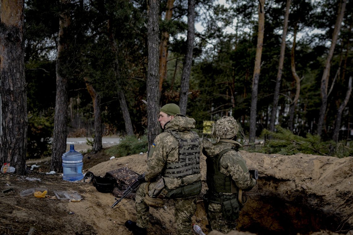 Ukrainian servicemen stand in a foxhole in Irpin, on the outskirts of Kyiv, Ukraine, Wednesday, March 9, 2022. A Russian airstrike devastated a maternity hospital Wednesday in the besieged port city of Mariupol amid growing warnings from the West that Moscow's invasion is about to take a more brutal and indiscriminate turn. (AP Photo/Vadim Ghirda) Ukrainian servicemen stand in a foxhole in Irpin, on the outskirts of Kyiv, Ukraine, Wednesday, March 9, 2022. A Russian airstrike devastated a maternity hospital Wednesday in the besieged port city of Mariupol amid growing warnings from the West that Moscow's invasion is about to take a more brutal and indiscriminate turn. (AP Photo/Vadim Ghirda)