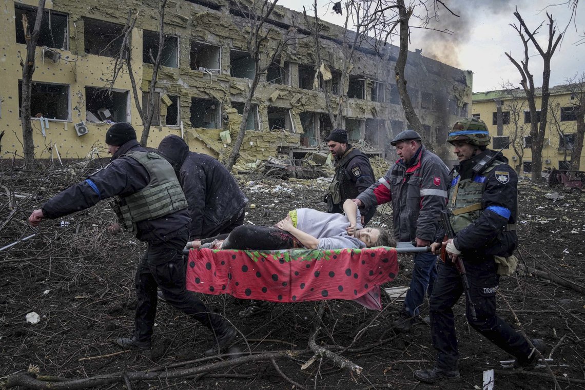 Ukrainian emergency employees and volunteers carry an injured pregnant woman from the damaged by shelling maternity hospital in Mariupol, Ukraine, Wednesday, March 9, 2022. A Russian attack has severely damaged a maternity hospital in the besieged port city of Mariupol, Ukrainian officials say. (AP Photo/Evgeniy Maloletka) Ukrainian emergency employees and volunteers carry an injured pregnant woman from the damaged by shelling maternity hospital in Mariupol, Ukraine, Wednesday, March 9, 2022. A Russian attack has severely damaged a maternity hospital in the besieged port city of Mariupol, Ukrainian officials say. (AP Photo/Evgeniy Maloletka)