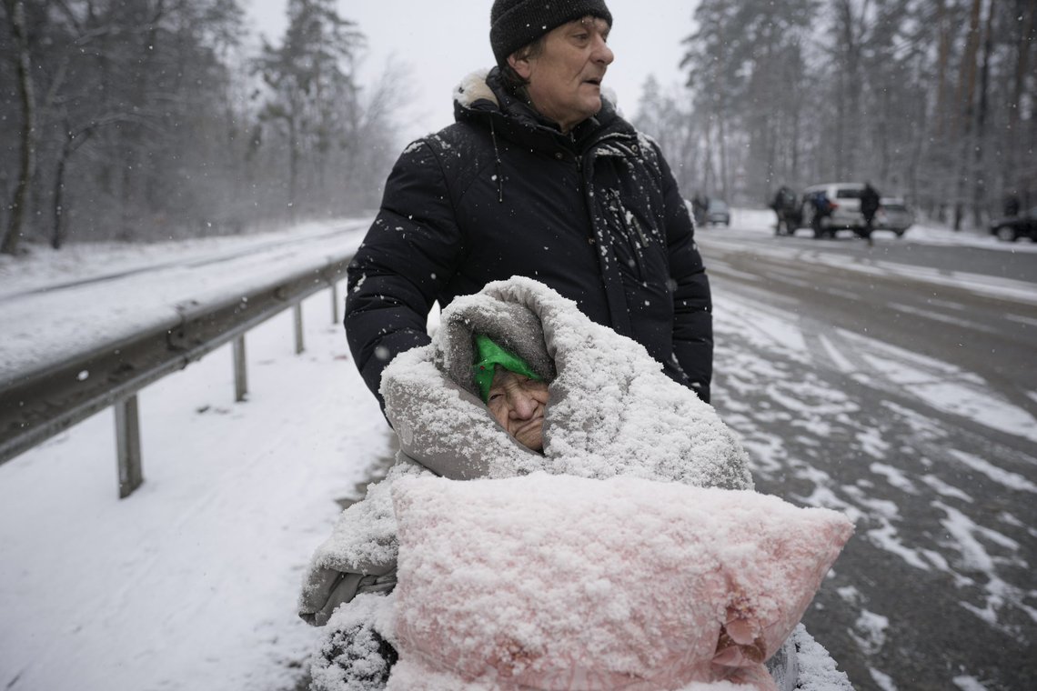 An elderly woman is coated in snow as she sits in a wheelchair after being evacuated from Irpin, on the outskirts of Kyiv, Ukraine, Tuesday, March 8, 2022. (AP Photo/Vadim Ghirda) An elderly woman is coated in snow as she sits in a wheelchair after being evacuated from Irpin, on the outskirts of Kyiv, Ukraine, Tuesday, March 8, 2022. (AP Photo/Vadim Ghirda)