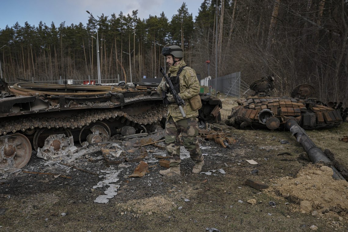 A Ukrainian serviceman walks next to the wreck of a Russian tank in Stoyanka, Ukraine, Sunday, March 27, 2022. Ukrainian President Volodymyr Zelenskyy accused the West of lacking courage as his country fights to stave off Russia's invading troops, making an exasperated plea for fighter jets and tanks to sustain a defense in a conflict that has ground into a war of attrition. (AP Photo/Vadim Ghirda) A Ukrainian serviceman walks next to the wreck of a Russian tank in Stoyanka, Ukraine, Sunday, March 27, 2022. Ukrainian President Volodymyr Zelenskyy accused the West of lacking courage as his country fights to stave off Russia's invading troops, making an exasperated plea for fighter jets and tanks to sustain a defense in a conflict that has ground into a war of attrition. (AP Photo/Vadim Ghirda)