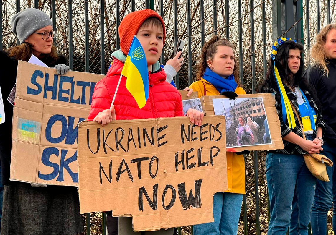 Protestors hold signs regarding Ukraine as they stand outside the security perimeter during a meeting of NATO defense ministers at NATO headquarters in Brussels, Wednesday, March 16, 2022. In talks at NATO's Brussels headquarters, U.S. Defense Secretary Lloyd Austin and his counterparts are weighing what defenses to erect on the organization's eastern flank, from Estonia in the north through Latvia, Lithuania and Poland down to Bulgaria and Romania on the Black Sea. (AP Photo/Sylvain Plazy) Protestors hold signs regarding Ukraine as they stand outside the security perimeter during a meeting of NATO defense ministers at NATO headquarters in Brussels, Wednesday, March 16, 2022. In talks at NATO's Brussels headquarters, U.S. Defense Secretary Lloyd Austin and his counterparts are weighing what defenses to erect on the organization's eastern flank, from Estonia in the north through Latvia, Lithuania and Poland down to Bulgaria and Romania on the Black Sea. (AP Photo/Sylvain Plazy)