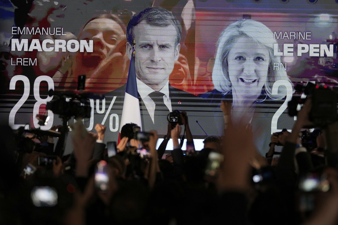 A screen shows French President Emmanuel Macron and centrist candidate for reelection and far-right candidate Marine Le Pen at her election day headquarters, in Paris, Sunday, April 10, 2022. French polling agency projections show incumbent French President Emmanuel Macron and far-right leader Marine Le Pen leading in the first round of France's presidential election Sunday. (AP Photo/Francois Mori) A screen shows French President Emmanuel Macron and centrist candidate for reelection and far-right candidate Marine Le Pen at her election day headquarters, in Paris, Sunday, April 10, 2022. French polling agency projections show incumbent French President Emmanuel Macron and far-right leader Marine Le Pen leading in the first round of France's presidential election Sunday. (AP Photo/Francois Mori)