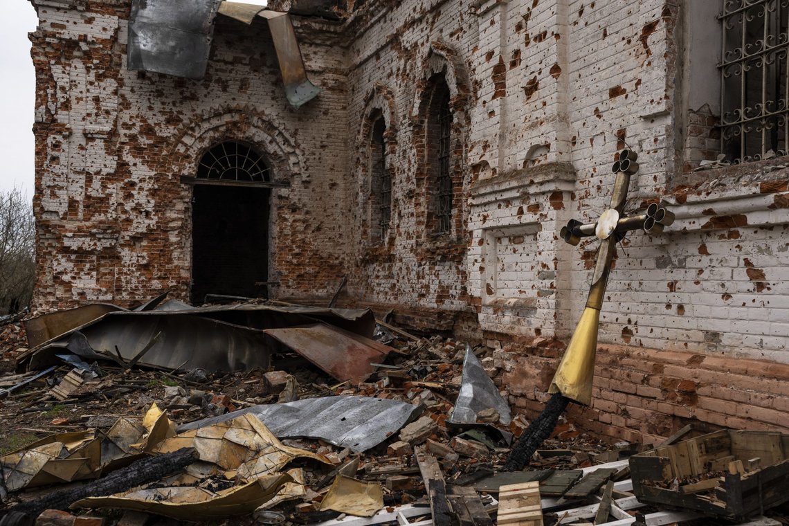 A metal cross that used to be on the top of the dome stands outside of the damaged church in Lukashivka, in northern Ukraine, on Friday, April 22, 2022. A single metal cross remains inside the Orthodox church of shattered brick and blackened stone. Residents say Russian soldiers used the house of worship for storing ammunition, and Ukrainian forces shelled the building to make the Russians leave. (AP Photo/Petros Giannakouris) A metal cross that used to be on the top of the dome stands outside of the damaged church in Lukashivka, in northern Ukraine, on Friday, April 22, 2022. A single metal cross remains inside the Orthodox church of shattered brick and blackened stone. Residents say Russian soldiers used the house of worship for storing ammunition, and Ukrainian forces shelled the building to make the Russians leave. (AP Photo/Petros Giannakouris)