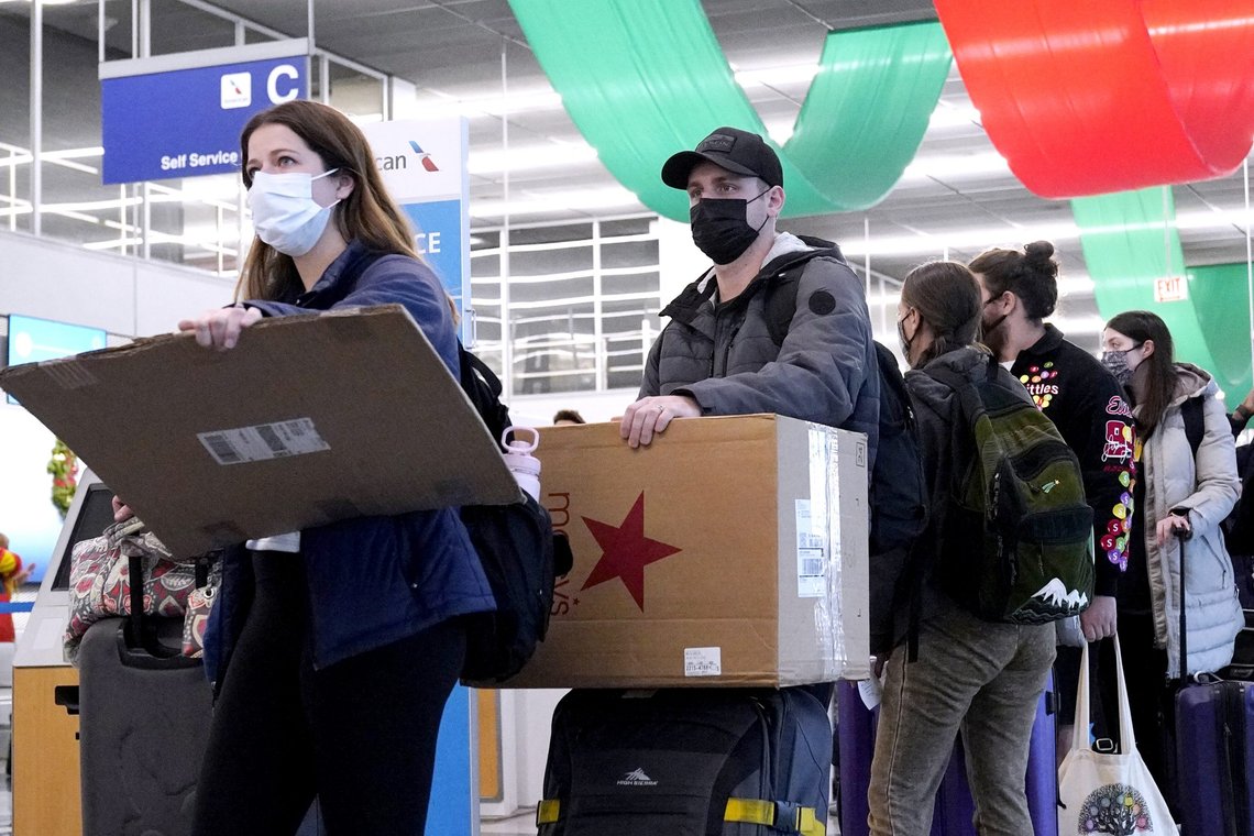 FILE - Travelers line up wearing protective masks indoors at O'Hare International Airport in Chicago, Dec. 28, 2021. U.S. District Judge Kathryn Kimball Mizelle in Tampa, Fla., on April 18, 2022, voided the national travel mask mandate as exceeding the authority of U.S. health officials. The mask mandate that covers travel on airplanes and other public transportation was recently extended by President Joe Biden's administration until May 3. (AP Photo/Nam Y. Huh, File) FILE - Travelers line up wearing protective masks indoors at O'Hare International Airport in Chicago, Dec. 28, 2021. U.S. District Judge Kathryn Kimball Mizelle in Tampa, Fla., on April 18, 2022, voided the national travel mask mandate as exceeding the authority of U.S. health officials. The mask mandate that covers travel on airplanes and other public transportation was recently extended by President Joe Biden's administration until May 3. (AP Photo/Nam Y. Huh, File)