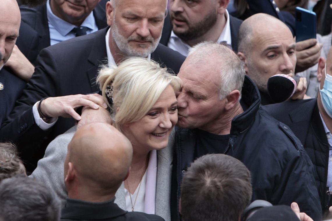 French far-right leader and presidential candidate Marine Le Pen is kissed by a supporter as she campaigns, Monday, April 18, 2022 in Saint-Pierre-en-Auge, Normandy. French President Emmanuel Macron is facing off against far-right challenger Marine Le Pen in France's April 24 presidential runoff. (AP Photo/Jeremias Gonzalez) French far-right leader and presidential candidate Marine Le Pen is kissed by a supporter as she campaigns, Monday, April 18, 2022 in Saint-Pierre-en-Auge, Normandy. French President Emmanuel Macron is facing off against far-right challenger Marine Le Pen in France's April 24 presidential runoff. (AP Photo/Jeremias Gonzalez)