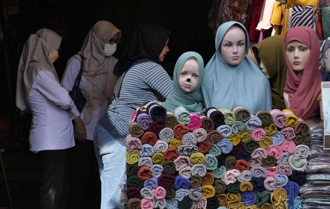 Women buy Muslim clothing during the last week of Ramadan at a market in Jakarta, Indonesia, Tuesday, April 26, 2022. People flock to markets and shopping malls in the capital city as they shop for food and new clothings in preparation for Eid al Fitr holiday next week marking the end of the holiest month in Islamic calendar. (AP Photo/Tatan Syuflana) Women buy Muslim clothing during the last week of Ramadan at a market in Jakarta, Indonesia, Tuesday, April 26, 2022. People flock to markets and shopping malls in the capital city as they shop for food and new clothings in preparation for Eid al Fitr holiday next week marking the end of the holiest month in Islamic calendar. (AP Photo/Tatan Syuflana)