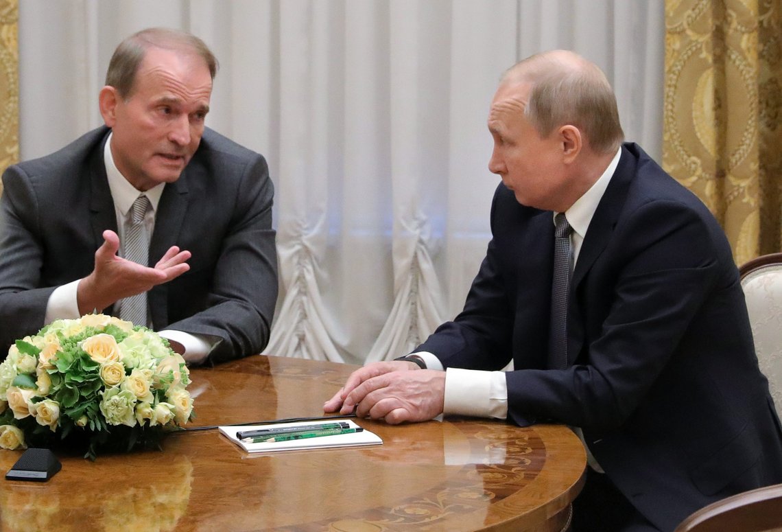 FILE- In this photo taken on, Thursday, July 18, 2019, Russian President Vladimir Putin's closest associates, Ukrainian tycoon Viktor Medvedchuk, left, speaks to Russian President Vladimir Putin during their meeting in St. Petersburg, Russia. Ukraine's Prosecutor General on Tuesday, May 11, 2021, has charged Medvedchuk with high treason, dealing a blow to Kremlin's lobby in Ukraine. (Mikhail Klimentyev, Sputnik, Kremlin Pool Photo via AP) FILE- In this photo taken on, Thursday, July 18, 2019, Russian President Vladimir Putin's closest associates, Ukrainian tycoon Viktor Medvedchuk, left, speaks to Russian President Vladimir Putin during their meeting in St. Petersburg, Russia. Ukraine's Prosecutor General on Tuesday, May 11, 2021, has charged Medvedchuk with high treason, dealing a blow to Kremlin's lobby in Ukraine. (Mikhail Klimentyev, Sputnik, Kremlin Pool Photo via AP)