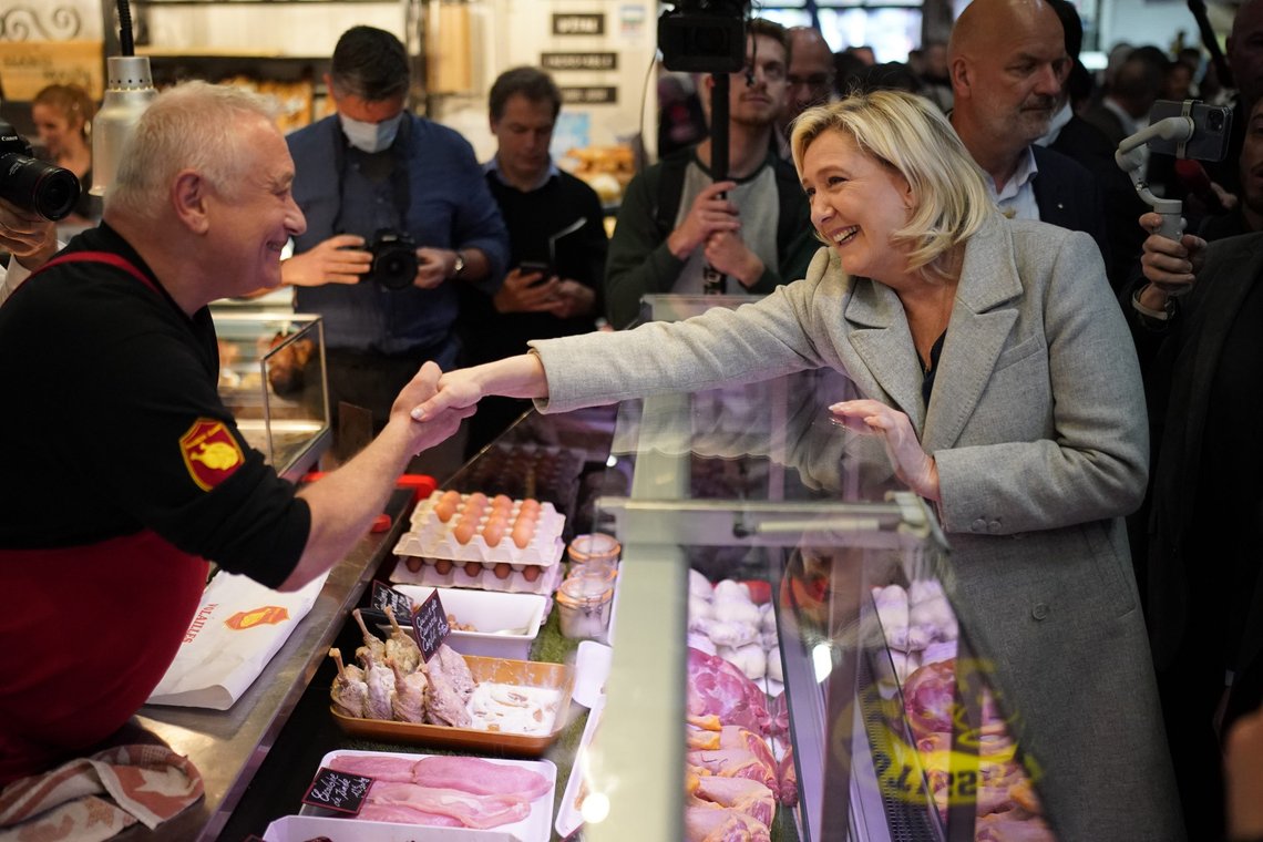 French far-right leader Marine Le Pen shakes hands to a butcher as she tours a food market in Narbonne, southern France, Friday, April 8, 2022. France's first round of the presidential election will take place on April 10, with a presidential runoff on April 24 if no candidate wins outright. (AP Photo/Joan Mateu Parra) French far-right leader Marine Le Pen shakes hands to a butcher as she tours a food market in Narbonne, southern France, Friday, April 8, 2022. France's first round of the presidential election will take place on April 10, with a presidential runoff on April 24 if no candidate wins outright. (AP Photo/Joan Mateu Parra)