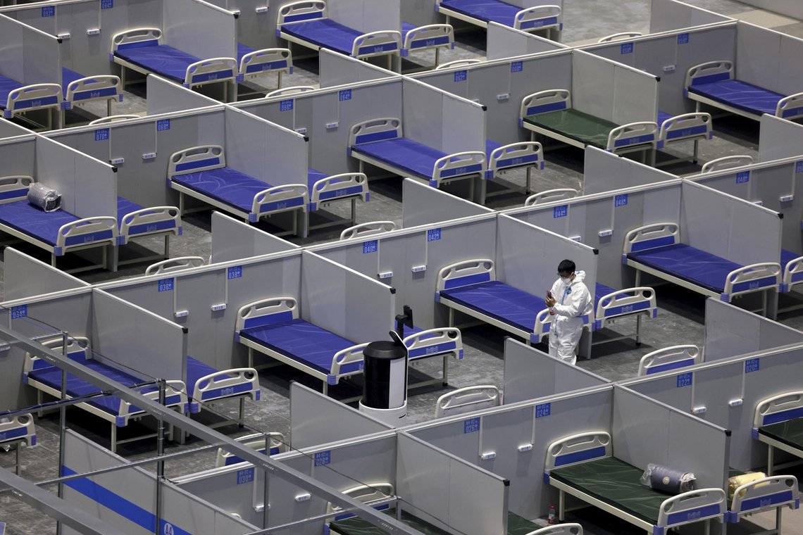 In this photo released by Xinhua News Agency, a staff member adjusts a robot at the construction site of a temporary hospital at the National Exhibition and Convention Center (Shanghai) in east China's Shanghai, Friday, April 8, 2022. China's largest city of Shanghai will soon begin lifting lockdown in communities that report no positive cases within 14 days after another round of COVID-19 testing, authorities said Saturday. (Jin Liwang/Xinhua via AP) In this photo released by Xinhua News Agency, a staff member adjusts a robot at the construction site of a temporary hospital at the National Exhibition and Convention Center (Shanghai) in east China's Shanghai, Friday, April 8, 2022. China's largest city of Shanghai will soon begin lifting lockdown in communities that report no positive cases within 14 days after another round of COVID-19 testing, authorities said Saturday. (Jin Liwang/Xinhua via AP)