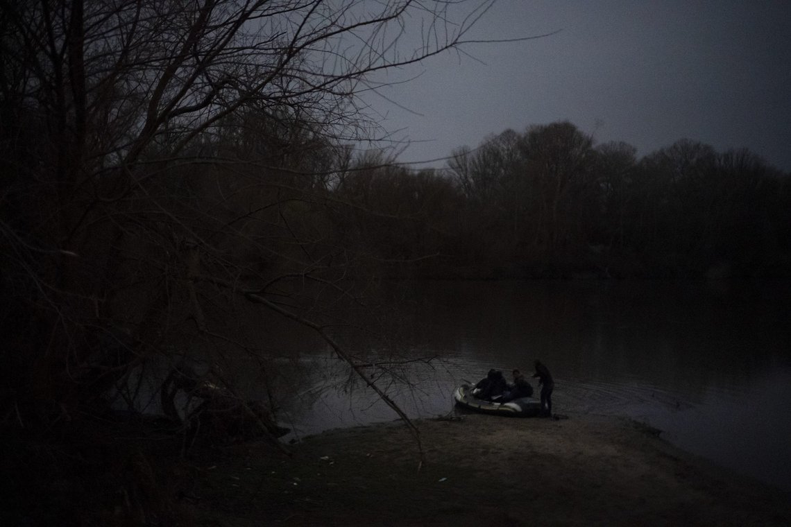 FILE - Migrants board an inflatable boat under moonlight as they attempt to enter Greece from Turkey by crossing the Evros river, also known as Maritsa river, near Edirne, Turkey, March 8, 2020. (AP Photo/Felipe Dana, File) FILE - Migrants board an inflatable boat under moonlight as they attempt to enter Greece from Turkey by crossing the Evros river, also known as Maritsa river, near Edirne, Turkey, March 8, 2020. (AP Photo/Felipe Dana, File)