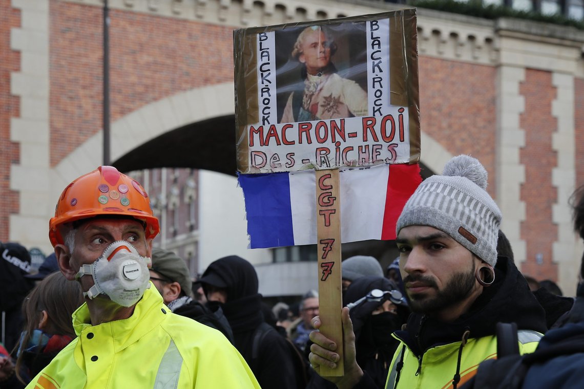 Yellow Vests protesters carry a poster depicting French President Emmanuel Macron as King Louis XVI and reading 'Macron, king of the the rich people" during a demonstration Saturday, Jan. 11, 2020 in Paris. The French government and labor unions appeared far from reaching any compromise deal Friday in talks over a planned pension overhaul, with strikes and protests grinding on. (AP Photo/Francois Mori) Yellow Vests protesters carry a poster depicting French President Emmanuel Macron as King Louis XVI and reading 'Macron, king of the the rich people" during a demonstration Saturday, Jan. 11, 2020 in Paris. The French government and labor unions appeared far from reaching any compromise deal Friday in talks over a planned pension overhaul, with strikes and protests grinding on. (AP Photo/Francois Mori)
