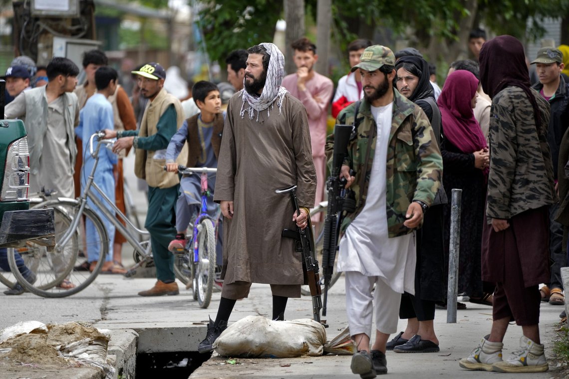 Taliban fighters stand guard as civilians gather at the site of an explosion in front of a school, in Kabul, Afghanistan, Tuesday, April 19, 2022. An Afghan police spokesman says explosions targeting educational institutions in Kabul have killed at least six civilians and injured over 10 others. Khalid Zadran said Tuesday the blasts occurred in the mostly-Shiite Muslim area in the west of Afghanistan's capital. (AP Photo/Ebrahim Noroozi) Taliban fighters stand guard as civilians gather at the site of an explosion in front of a school, in Kabul, Afghanistan, Tuesday, April 19, 2022. An Afghan police spokesman says explosions targeting educational institutions in Kabul have killed at least six civilians and injured over 10 others. Khalid Zadran said Tuesday the blasts occurred in the mostly-Shiite Muslim area in the west of Afghanistan's capital. (AP Photo/Ebrahim Noroozi)
