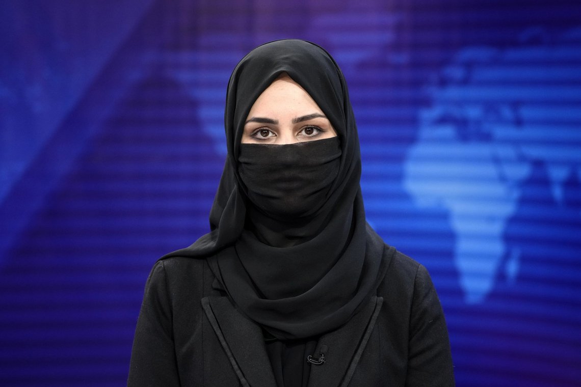 Khatereh Ahmadi a TV anchor reads news on TOLO NEWS studio while covering her face, in Kabul, Afghanistan, Sunday, May 22, 2022. Afghanistan's Taliban rulers have begun enforcing an order requiring all female TV news anchors in the country to cover their faces while on-air. The move Sunday is part of a hard-line shift drawing condemnation from rights activists. (AP Photo/Ebrahim Noroozi) Khatereh Ahmadi a TV anchor reads news on TOLO NEWS studio while covering her face, in Kabul, Afghanistan, Sunday, May 22, 2022. Afghanistan's Taliban rulers have begun enforcing an order requiring all female TV news anchors in the country to cover their faces while on-air. The move Sunday is part of a hard-line shift drawing condemnation from rights activists. (AP Photo/Ebrahim Noroozi)