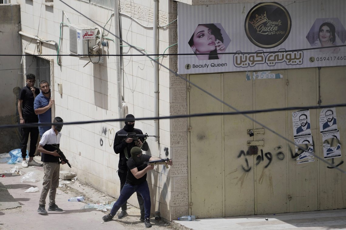Palestinian gunmen take aim during an Israeli military operation in the West Bank town of Jenin, Friday, May 13, 2022. Israeli troops pushed into Jenin early Friday following the death of veteran Al Jazeera correspondent Serine Abu Akleh on Wednesday when she was shot dead by Israeli forces while covering a military operation in the occupied West Bank. (AP Photo/Majdi Mohammed) Palestinian gunmen take aim during an Israeli military operation in the West Bank town of Jenin, Friday, May 13, 2022. Israeli troops pushed into Jenin early Friday following the death of veteran Al Jazeera correspondent Serine Abu Akleh on Wednesday when she was shot dead by Israeli forces while covering a military operation in the occupied West Bank. (AP Photo/Majdi Mohammed)