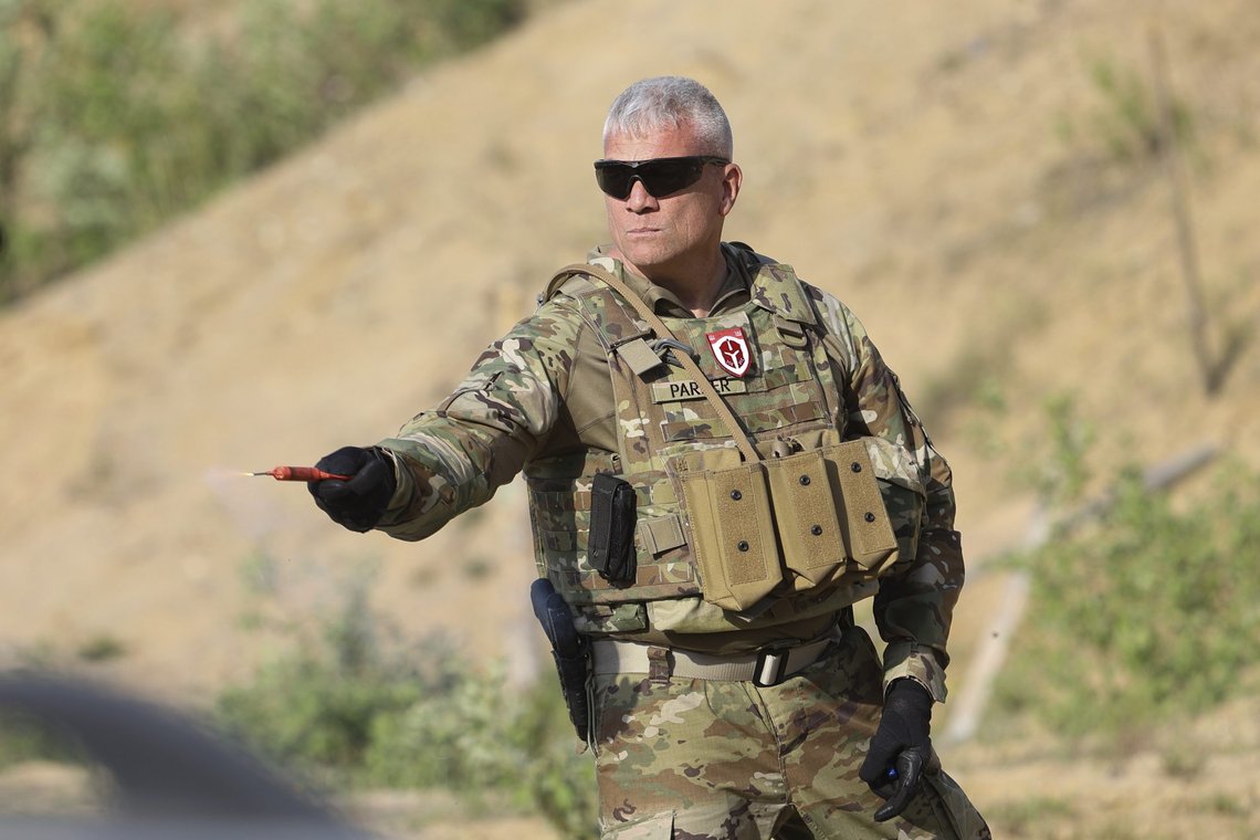 American former army member, Matthew Parker, holds a smoke grenade during a training session for Belarusian volunteers at a shooting range near Warsaw, Poland, on Friday, May 20, 2022. Belarusians are among those who have answered a call by Ukrainian President Volodymyr Zelenskyy for foreign fighters to go to Ukraine and join the International Legion for the Territorial Defense of Ukraine. (AP Photo/Michal Dyjuk) American former army member, Matthew Parker, holds a smoke grenade during a training session for Belarusian volunteers at a shooting range near Warsaw, Poland, on Friday, May 20, 2022. Belarusians are among those who have answered a call by Ukrainian President Volodymyr Zelenskyy for foreign fighters to go to Ukraine and join the International Legion for the Territorial Defense of Ukraine. (AP Photo/Michal Dyjuk)