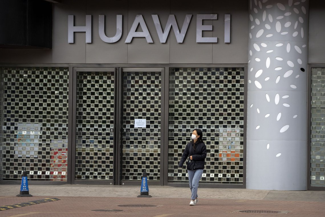 A woman wearing a face mask walks past a Huawei store temporarily closed due to coronavirus-related restrictions in Beijing, Thursday, May 12, 2022. China's leaders are struggling to reverse a deepening economic slump while keeping a "zero-COVID" strategy that has shut down Shanghai and other cities. (AP Photo/Mark Schiefelbein) A woman wearing a face mask walks past a Huawei store temporarily closed due to coronavirus-related restrictions in Beijing, Thursday, May 12, 2022. China's leaders are struggling to reverse a deepening economic slump while keeping a "zero-COVID" strategy that has shut down Shanghai and other cities. (AP Photo/Mark Schiefelbein)