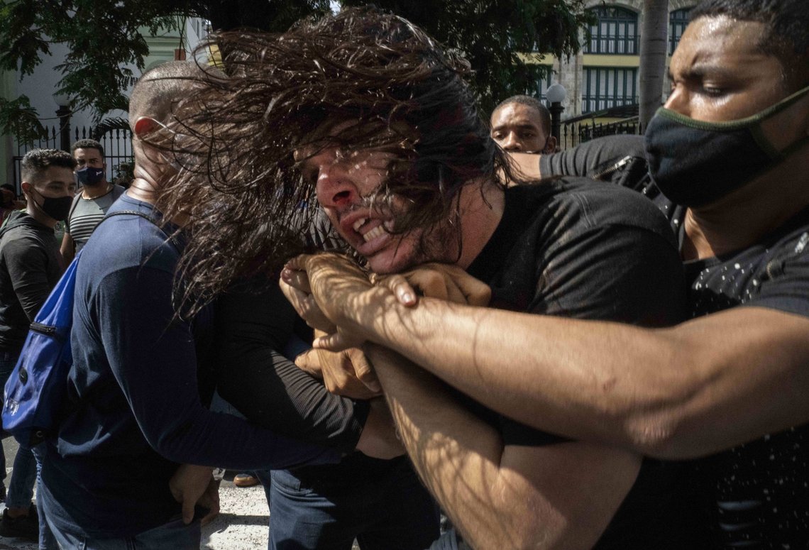 FILE - In this July 11, 2021 file photo, plainclothes police detain an anti-government protester during a demonstration over high prices, food shortages and power outages, while some also called for a change in the government, in Havana, Cuba. Since the protests erupted 11 months ago, the courts report that 381 persons have been sentenced and sanctioned for their acts. (AP Photo/Ramon Espinosa, File) FILE - In this July 11, 2021 file photo, plainclothes police detain an anti-government protester during a demonstration over high prices, food shortages and power outages, while some also called for a change in the government, in Havana, Cuba. Since the protests erupted 11 months ago, the courts report that 381 persons have been sentenced and sanctioned for their acts. (AP Photo/Ramon Espinosa, File)