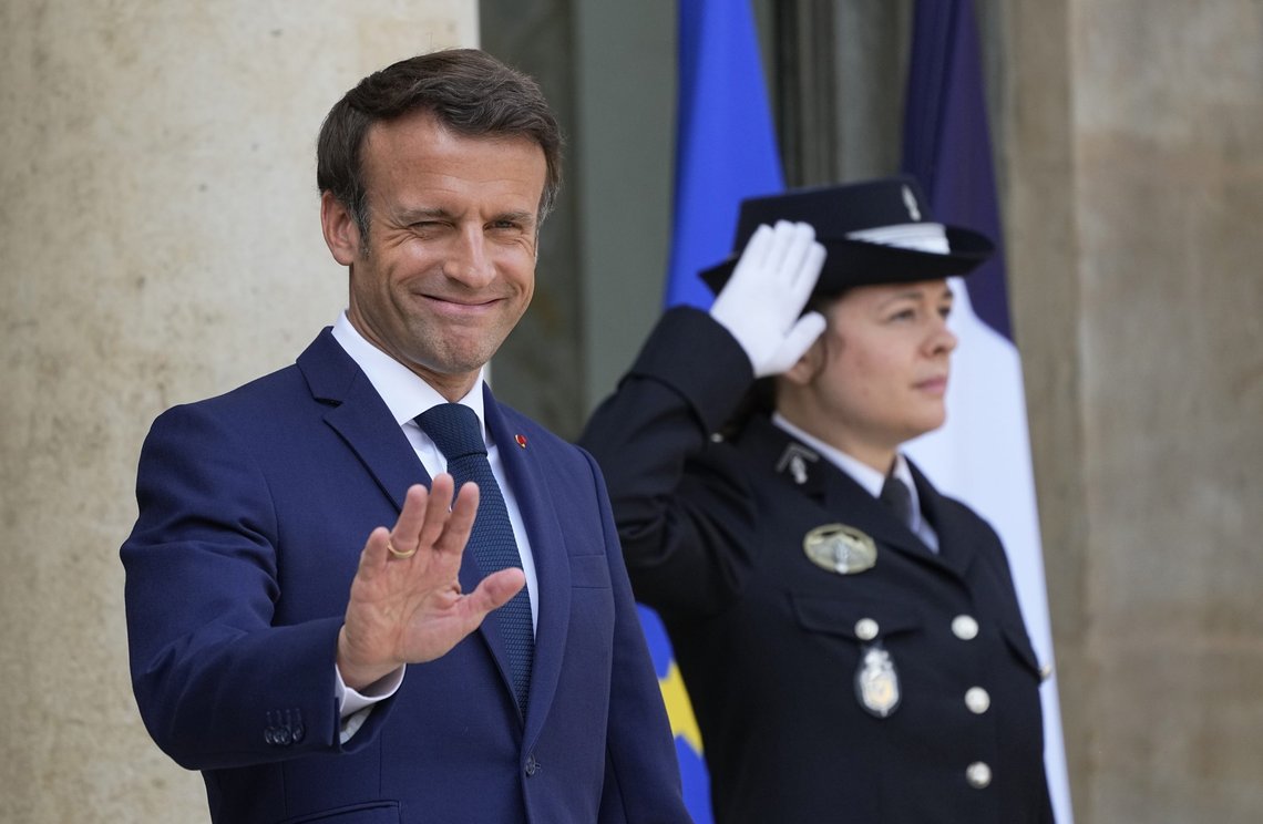 FILE - French President Emmanuel Macron greets the media as he awaits European Council President Charles Michel for lunch at the Elysee Palace, Monday May16, 2022. French voters were choosing lawmakers in a parliamentary election Sunday, June 12, 2022 as President Emmanuel Macron seeks to secure his majority while under growing threat from a leftist coalition. (AP Photo/Michel Euler, File) FILE - French President Emmanuel Macron greets the media as he awaits European Council President Charles Michel for lunch at the Elysee Palace, Monday May16, 2022. French voters were choosing lawmakers in a parliamentary election Sunday, June 12, 2022 as President Emmanuel Macron seeks to secure his majority while under growing threat from a leftist coalition. (AP Photo/Michel Euler, File)