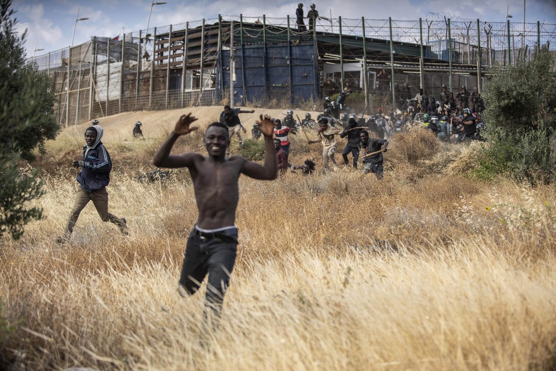 Migrants run on Spanish soil after crossing the fences separating the Spanish enclave of Melilla from Morocco in Melilla, Spain, Friday, June 24, 2022. Dozens of migrants stormed the border crossing between Morocco and the Spanish enclave city of Melilla on Friday in what is the first such incursion since Spain and Morocco mended diplomatic relations last month. (AP Photo/Javier Bernardo) Migrants run on Spanish soil after crossing the fences separating the Spanish enclave of Melilla from Morocco in Melilla, Spain, Friday, June 24, 2022. Dozens of migrants stormed the border crossing between Morocco and the Spanish enclave city of Melilla on Friday in what is the first such incursion since Spain and Morocco mended diplomatic relations last month. (AP Photo/Javier Bernardo)