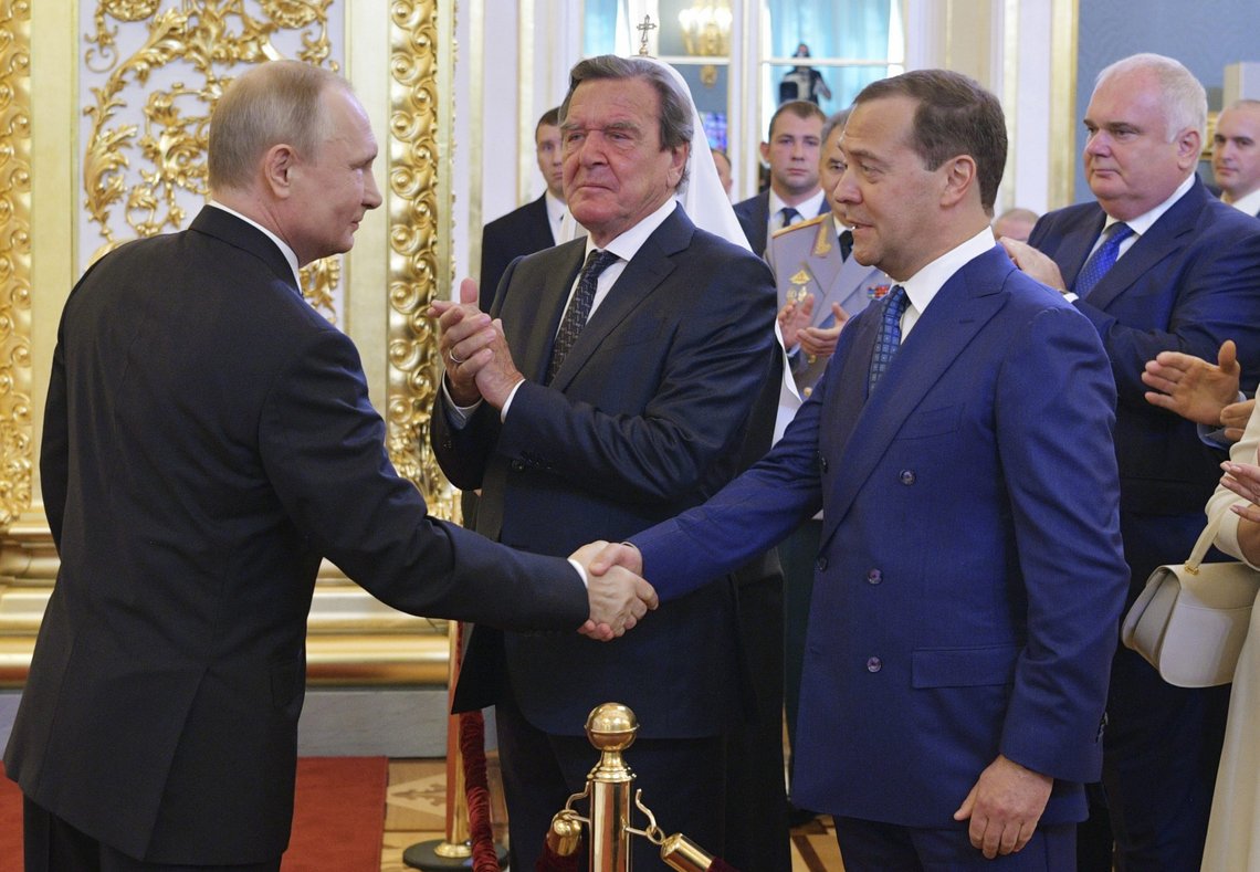 FILE - Vladimir Putin shakes hands with Dmitry Medvedev during his inauguration ceremony as new Russia's president in the Grand Kremlin Palace in Moscow, Russia, on May 7, 2018, with former German Chancellor Gerhard Schroeder in centre. Gerhard Schroeder left the German chancellery after a narrow election defeat in 2005 with an ambitious overhaul of the country’s welfare state beginning to kick in and every chance of becoming a respected elder statesman. Fast-forward to last week: German lawmakers agreed to shut down Schroeder’s taxpayer-funded office, the European Parliament called for him to be sanctioned, and his own party set a mid-June hearing on applications to have him expelled. Schroeder’s association with the Russian energy sector turned the 78-year-old into a political pariah in Germany after the invasion of Ukraine. (Alexei Druzhinin, Sputnik, Kremlin Pool Photo via AP) FILE - Vladimir Putin shakes hands with Dmitry Medvedev during his inauguration ceremony as new Russia's president in the Grand Kremlin Palace in Moscow, Russia, on May 7, 2018, with former German Chancellor Gerhard Schroeder in centre. Gerhard Schroeder left the German chancellery after a narrow election defeat in 2005 with an ambitious overhaul of the country’s welfare state beginning to kick in and every chance of becoming a respected elder statesman. Fast-forward to last week: German lawmakers agreed to shut down Schroeder’s taxpayer-funded office, the European Parliament called for him to be sanctioned, and his own party set a mid-June hearing on applications to have him expelled. Schroeder’s association with the Russian energy sector turned the 78-year-old into a political pariah in Germany after the invasion of Ukraine. (Alexei Druzhinin, Sputnik, Kremlin Pool Photo via AP)