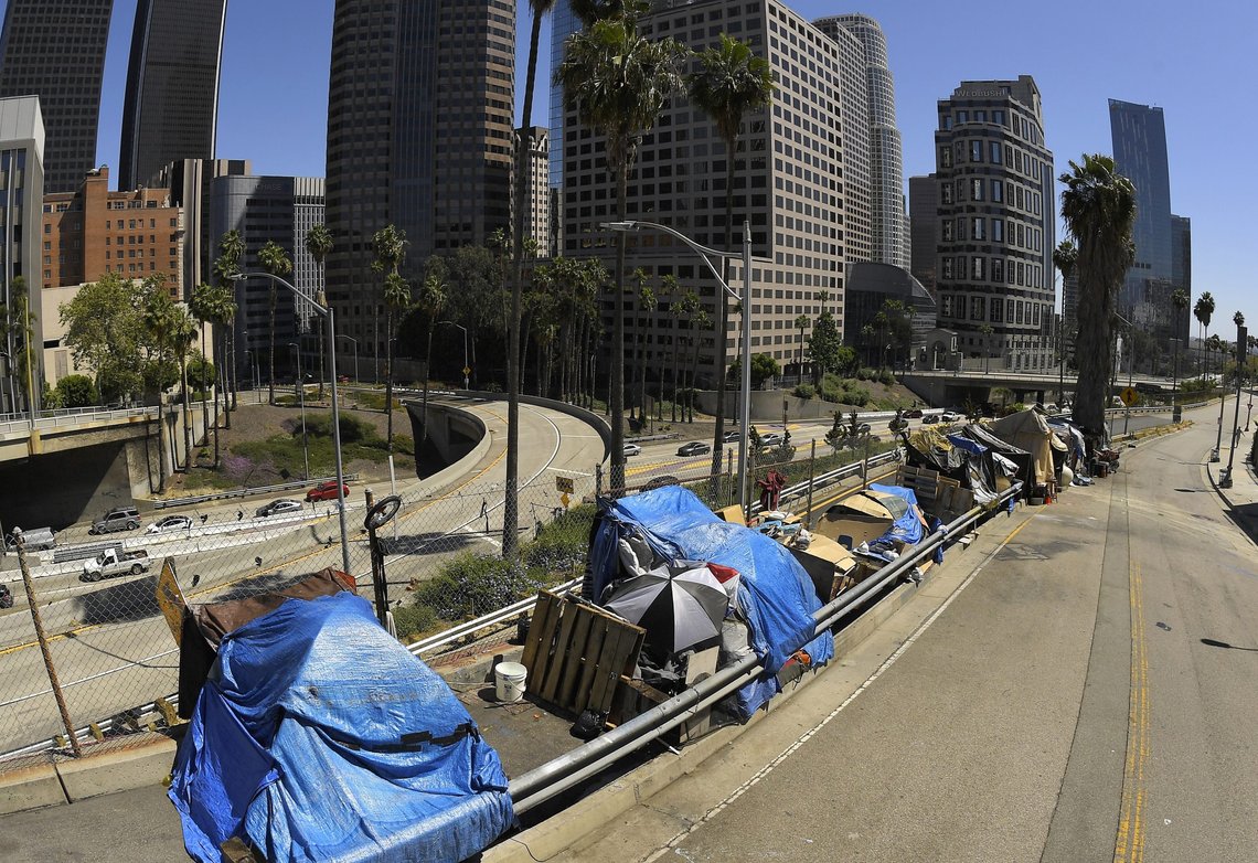 FILE - This May 21, 2020, file photo shows a homeless encampment on Beaudry Avenue as traffic moves along Interstate 110 in downtown Los Angeles. Seven new laws aimed at homelessness will take effect, Jan. 1, 2022. (AP Photo/Mark J. Terrill, File) FILE - This May 21, 2020, file photo shows a homeless encampment on Beaudry Avenue as traffic moves along Interstate 110 in downtown Los Angeles. Seven new laws aimed at homelessness will take effect, Jan. 1, 2022. (AP Photo/Mark J. Terrill, File)