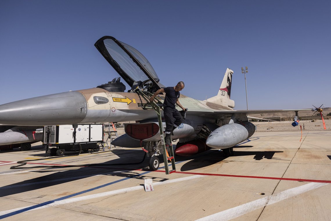 An Israeli F-16I technician checks an air force fighter jet during the bi-annual multi-national aerial exercise known as the Blue Flag, at Ovda airbase near Eilat, southern Israel, Sunday, Oct. 24, 2021. Israel's military is holding the largest ever air drill of its kind with participation from eight countries including the U.S., Britain, Germany, Italy, Greece, India and France in the two week-long drill. (AP Photo/Tsafrir Abayov) An Israeli F-16I technician checks an air force fighter jet during the bi-annual multi-national aerial exercise known as the Blue Flag, at Ovda airbase near Eilat, southern Israel, Sunday, Oct. 24, 2021. Israel's military is holding the largest ever air drill of its kind with participation from eight countries including the U.S., Britain, Germany, Italy, Greece, India and France in the two week-long drill. (AP Photo/Tsafrir Abayov)