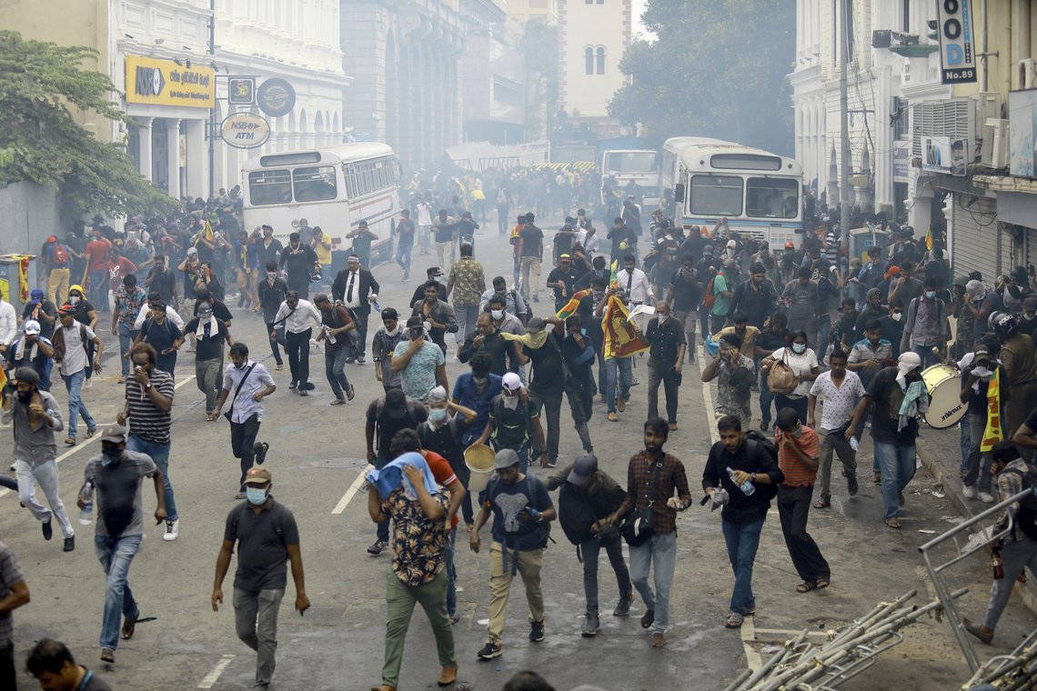 Protestors run after police used tear gas to disperse them in Colombo, Sri Lanka, Saturday, July 9, 2022. Sri Lankan protesters demanding that President Gotabaya Rajapaksa resign forced their way into his official residence on Saturday, a local television report said, as thousands of people took to the streets in the capital decrying the island nation's worst economic crisis in recent memory. (AP Photo/Amitha Thennakoon) Protestors run after police used tear gas to disperse them in Colombo, Sri Lanka, Saturday, July 9, 2022. Sri Lankan protesters demanding that President Gotabaya Rajapaksa resign forced their way into his official residence on Saturday, a local television report said, as thousands of people took to the streets in the capital decrying the island nation's worst economic crisis in recent memory. (AP Photo/Amitha Thennakoon)