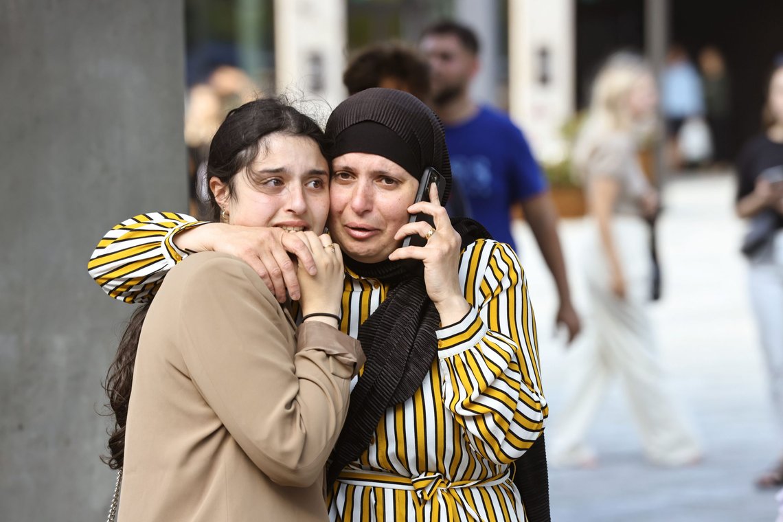 People evacuated from the Fields shopping center react, in Orestad, Copenhagen, Denmark, Sunday, July 3, 2022, after reports of shots fired. (Olafur Steinar Gestsson /Ritzau Scanpix via AP) People evacuated from the Fields shopping center react, in Orestad, Copenhagen, Denmark, Sunday, July 3, 2022, after reports of shots fired. (Olafur Steinar Gestsson /Ritzau Scanpix via AP)