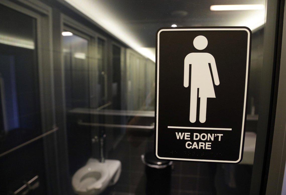 FILE - In this May 12, 2016, file photo, signage hangs outside a restroom at 21c Museum Hotel in Durham, N.C., May 12, 2016. Title IX, the landmark piece of U.S. legislation that was meant to ensure equity between men and women in education, turns 50 on June 23. Title IX was invoked when the Obama administration advised that transgender people should be allowed to use the bathroom of their choice in schools. (AP Photo/Gerry Broome, File) FILE - In this May 12, 2016, file photo, signage hangs outside a restroom at 21c Museum Hotel in Durham, N.C., May 12, 2016. Title IX, the landmark piece of U.S. legislation that was meant to ensure equity between men and women in education, turns 50 on June 23. Title IX was invoked when the Obama administration advised that transgender people should be allowed to use the bathroom of their choice in schools. (AP Photo/Gerry Broome, File)