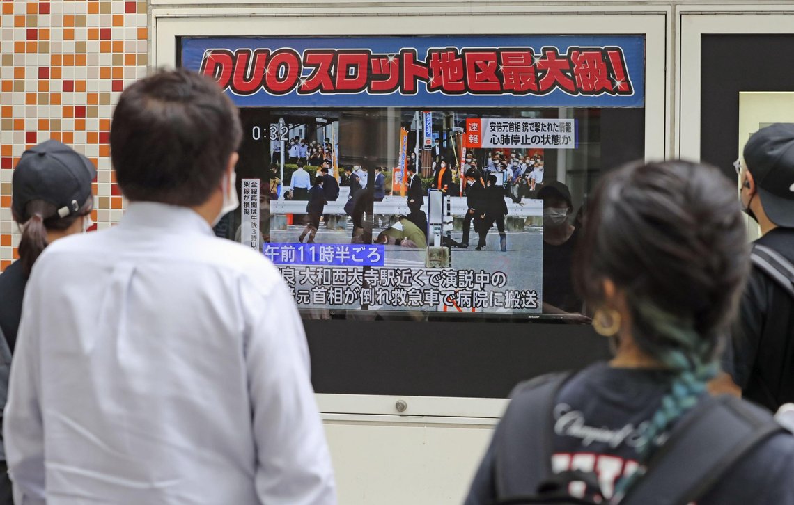 People watch TV news reporting Japan’s former Prime Minister Shinzo Abe was shot, in Tokyo, Friday, July 8, 2022. Japan’s former Prime Minister Shinzo Abe was shot during a campaign speech Friday in western Japan and was airlifted to a nearby hospital but he was not breathing and his heart had stopped, officials said.(Kyodo News via AP) People watch TV news reporting Japan’s former Prime Minister Shinzo Abe was shot, in Tokyo, Friday, July 8, 2022. Japan’s former Prime Minister Shinzo Abe was shot during a campaign speech Friday in western Japan and was airlifted to a nearby hospital but he was not breathing and his heart had stopped, officials said.(Kyodo News via AP)