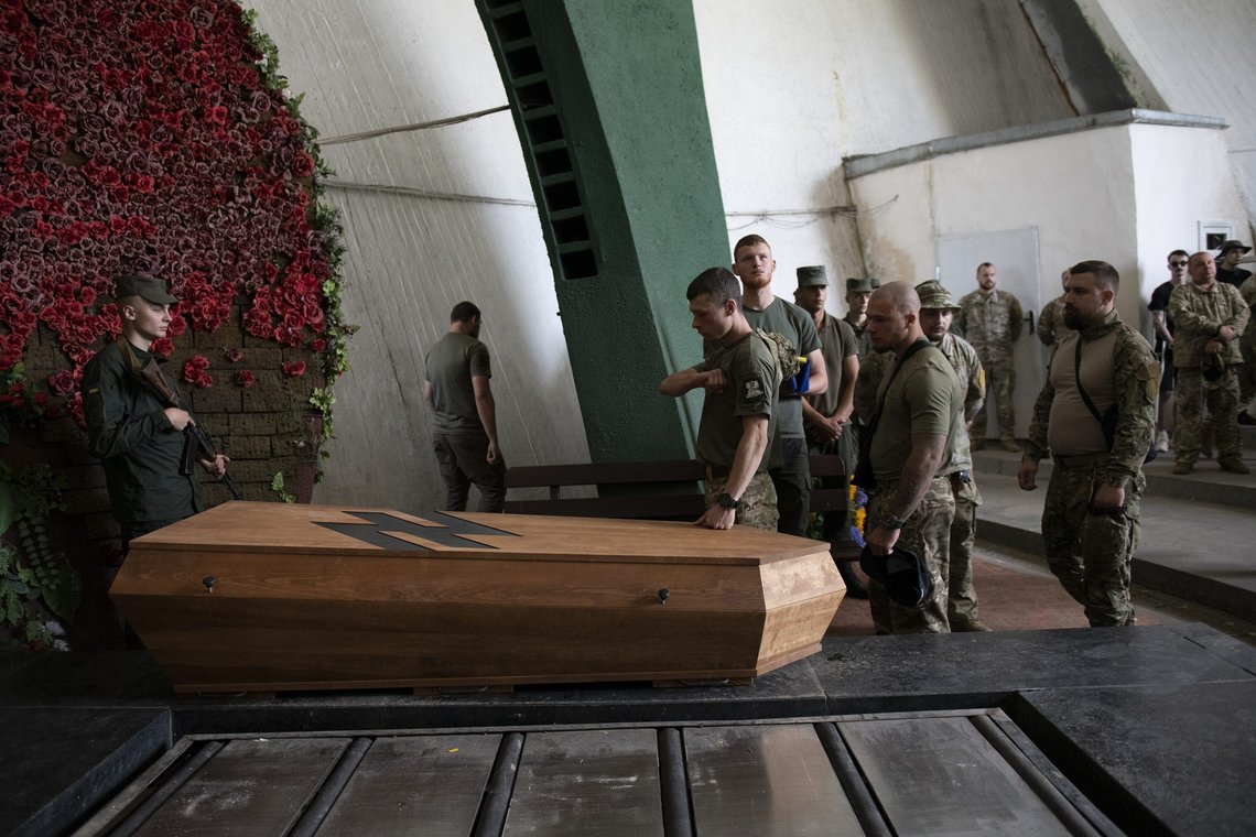Officers of the Azov regiment pay their last tribute to a serviceman killed in a battle against the Russian troops in a city crematorium in Kyiv, Ukraine, Thursday, July 21, 2022. (AP Photo/Andrew Kravchenko) Officers of the Azov regiment pay their last tribute to a serviceman killed in a battle against the Russian troops in a city crematorium in Kyiv, Ukraine, Thursday, July 21, 2022. (AP Photo/Andrew Kravchenko)
