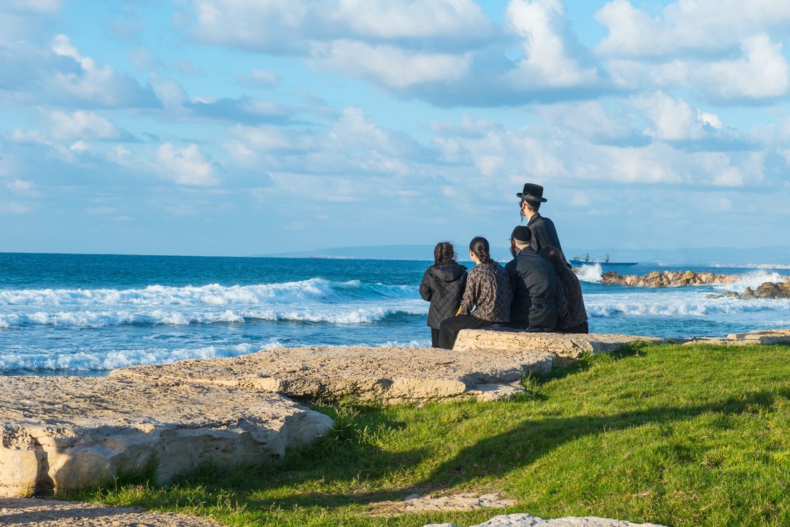 Religious Jewish family sitting on the coast of Mediterranean sea in Israel and watching the waves. Shutterstock contributor: Okrasiuk United Kingdom Religious Jewish family sitting on the coast of Mediterranean sea in Israel and watching the waves. Shutterstock contributor: Okrasiuk United Kingdom